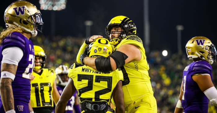 Oregon Ducks offensive lineman Jackson Powers-Johnson hugs running back Noah Whittington after a touchdown against the Washington huskies.